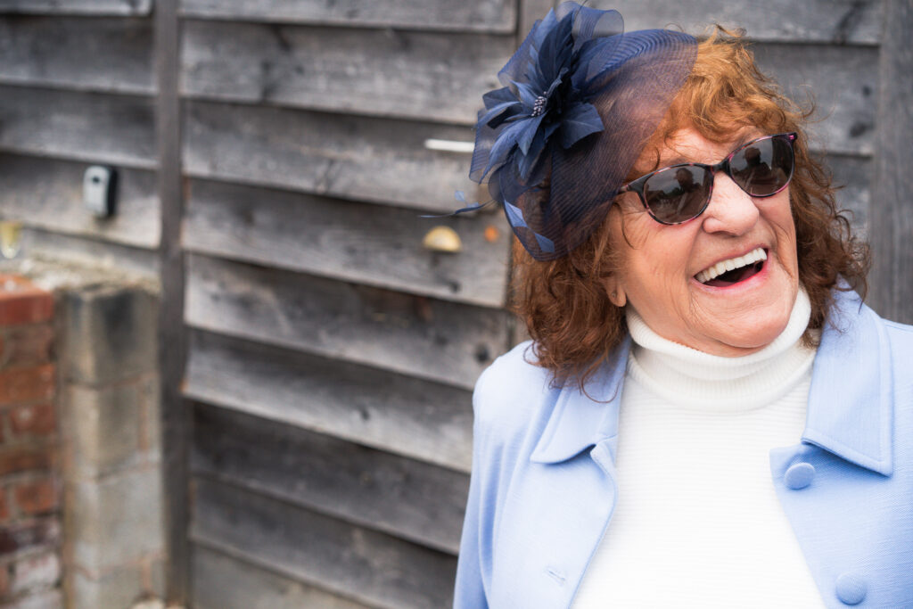 smiley guest laughing at a wedding 