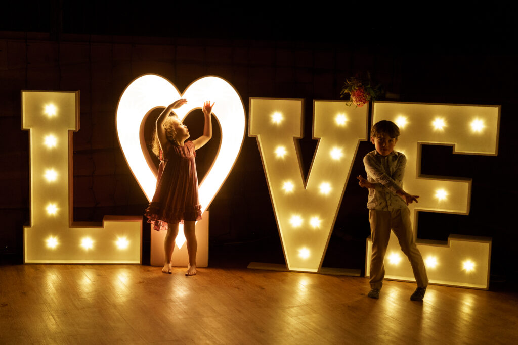 giant love letters on dancefloor at wedding reception