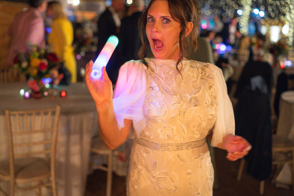 bride with glowstick at her wedding 