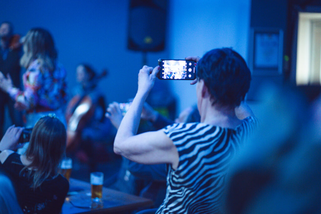 fan taking photo of a band