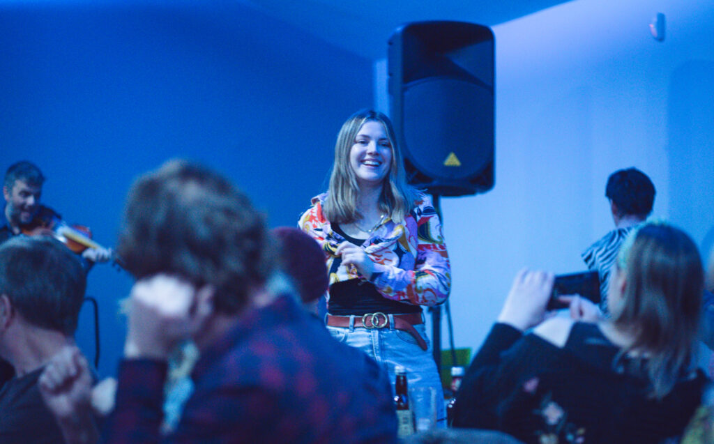 young woman smiling at benefit concert