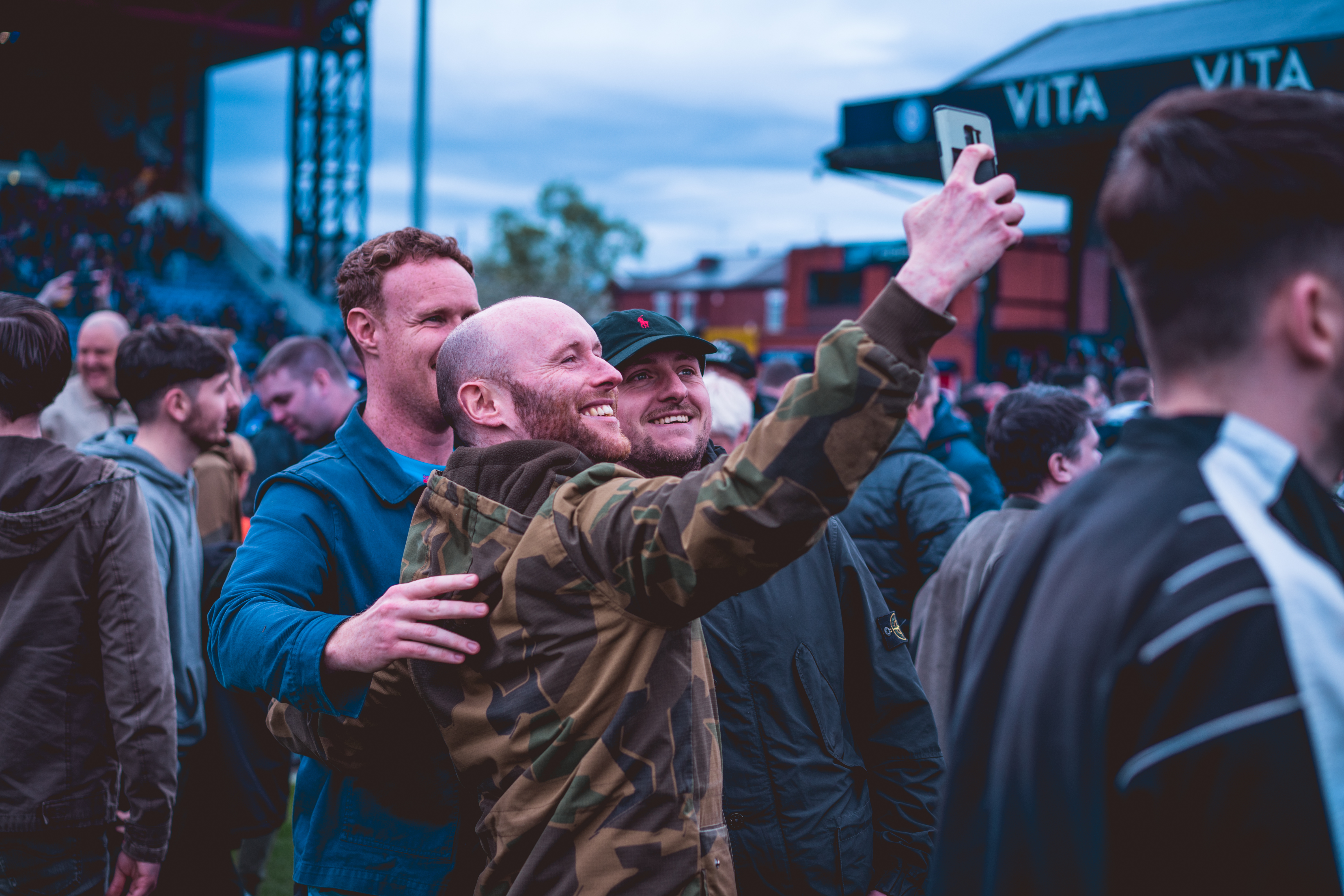 fans taking selfies on the pitch