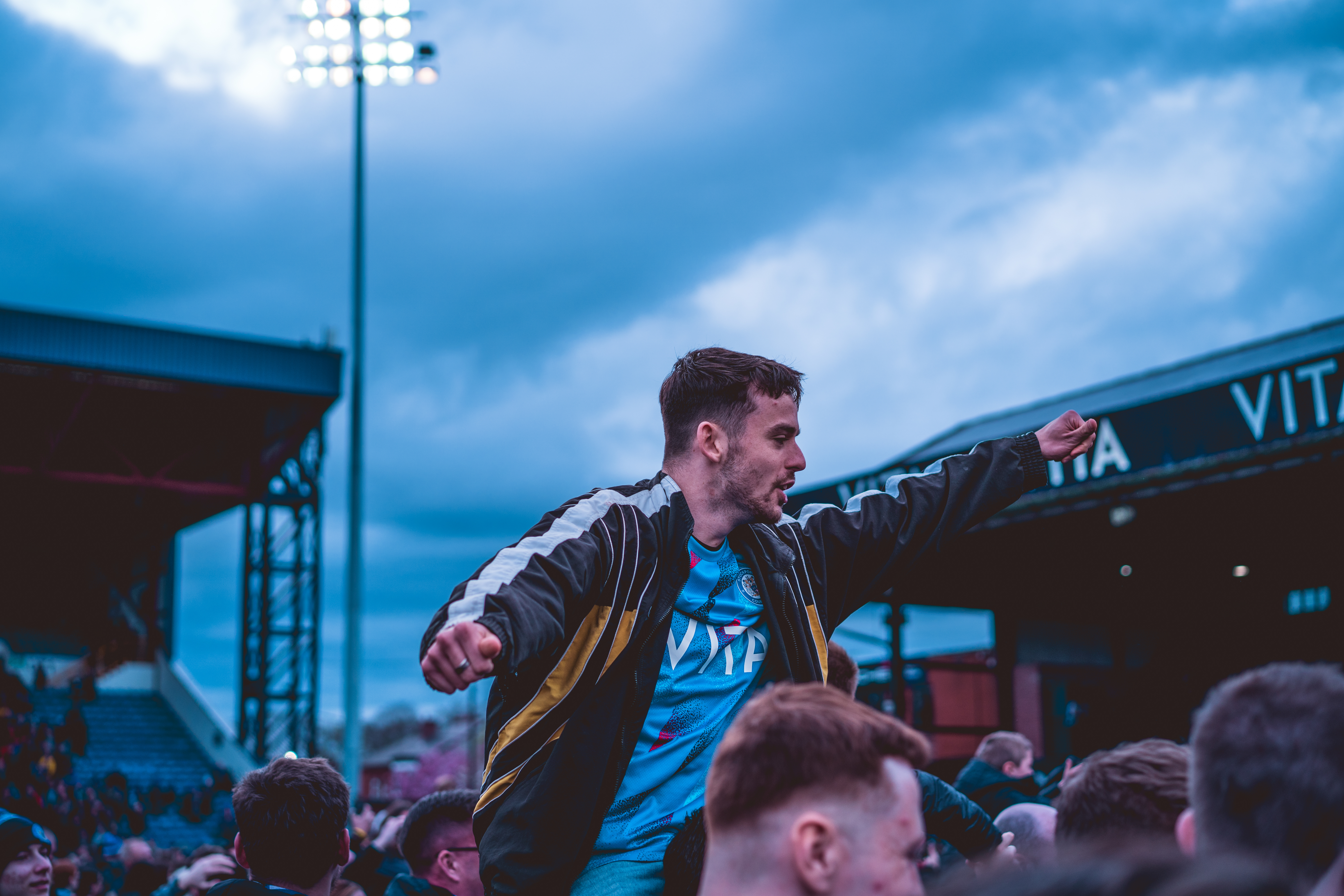 man on friend's shoulders at stockport county