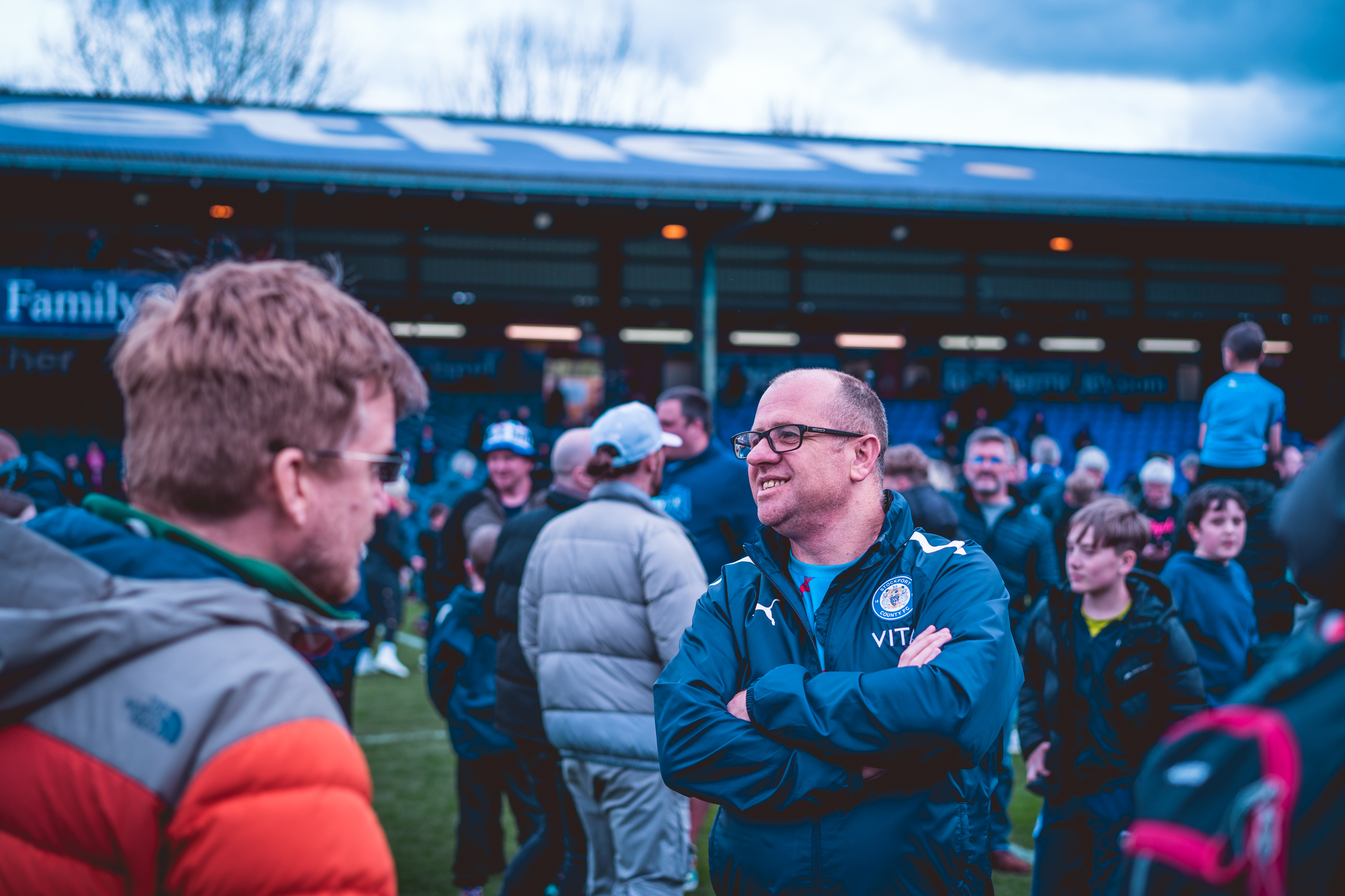 fans on the pitch at edgeley park